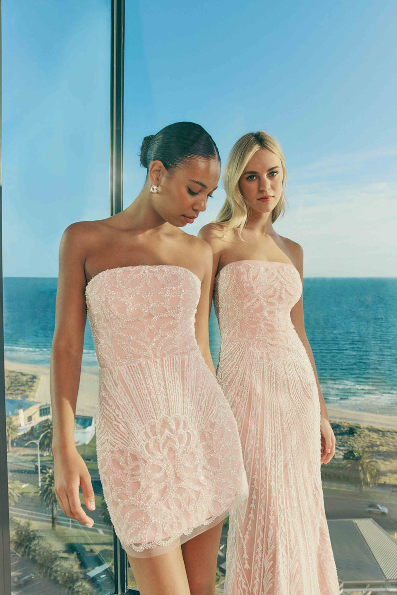 Brunette model wearing Kiki Strapless Mini Dress in Pink campaign shot