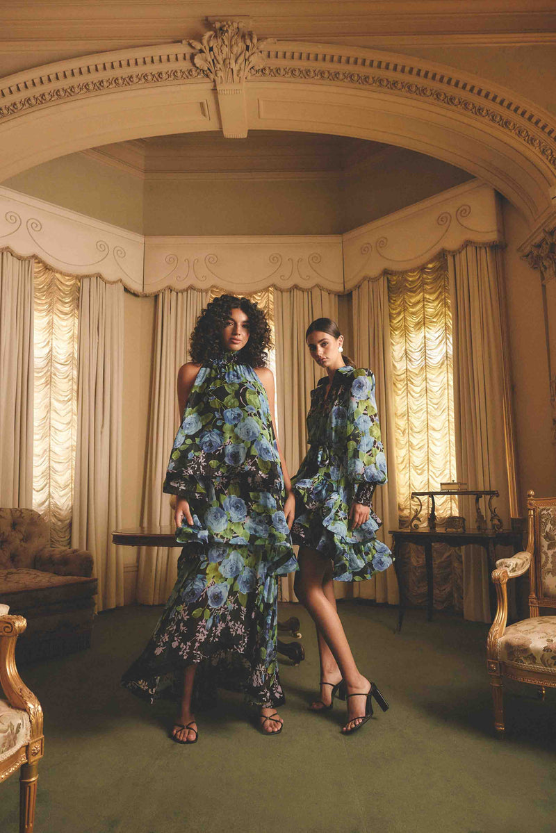 Blonde model wearing the Briony Tiered Gown in Black & Blue Floral campaign shot