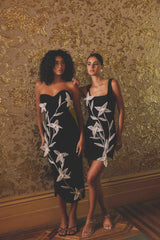 Brunette model wearing ILARIA MINI DRESS in black campaign shot