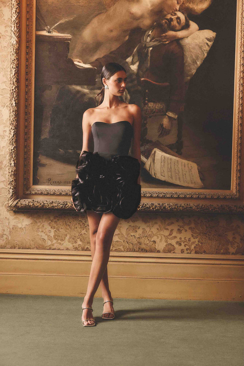 Blonde model wearing Asher Strapless Mini Dress in Black campaign shot