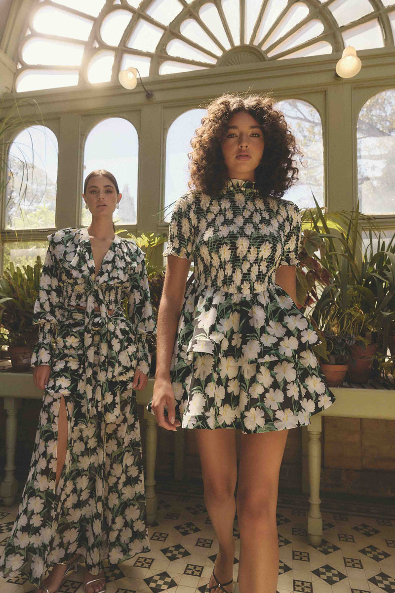 Brunette model wearing Rosey Short Sleeve Mini Dress in Black Floral campaign shot