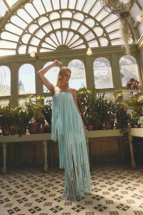 Brunette model wearing the Alya Tiered Maxi Dress in Blue close up campaign shot