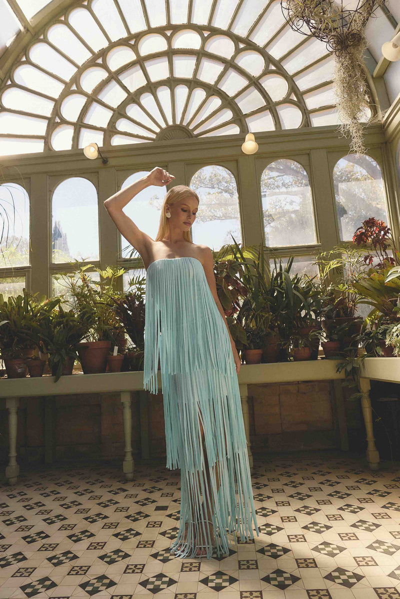 Brunette model wearing the Alya Tiered Maxi Dress in Blue close up campaign shot