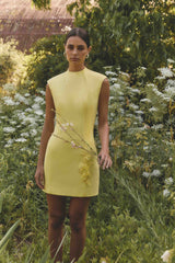 Brunette model wearing Evee High Neck Mini Dress in Yellow campaign shot
