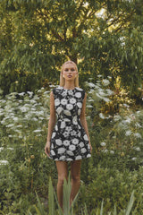 Brunette model wearing the Carol Tulip Mini Dres in Black & White campaign shot