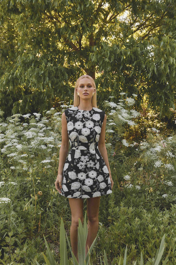 Brunette model wearing the Carol Tulip Mini Dres in Black & White campaign shot