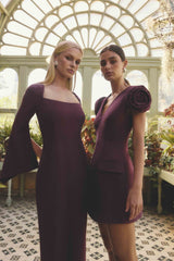 Blonde model wearing the Theresa Long Sleeve Gown in Burgundy campaign shot