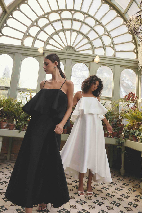 Brunette model wearing Reyna Tiered Maxi Dress in Black campaign shot