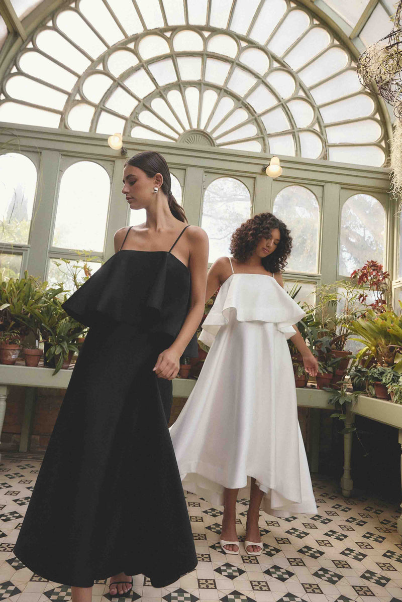 Brunette model wearing Reyna Tiered Maxi Dress in Black campaign shot