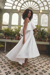 Brunette model wearing Reyna Tiered Maxi Dress in White campaign shot