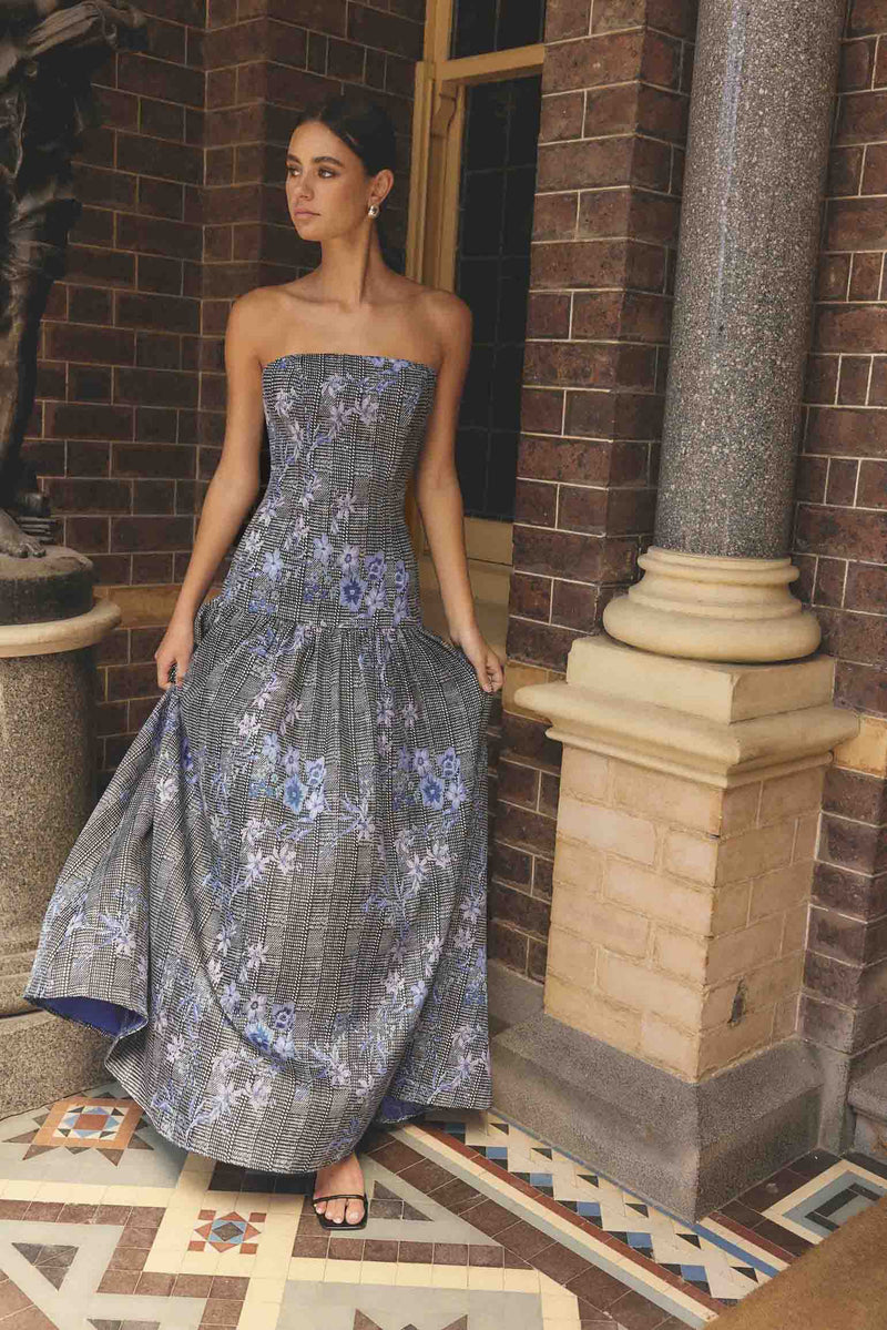 Brunette model wearing Allana Jacquard Strapless Gown in Black & Blue Floral campaign shot