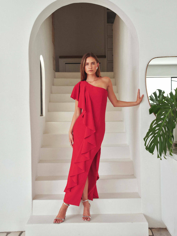 Brunette model wearing the Lila Asymmetrical Gown in Red campaign shot