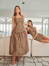 Brunette model wearing Elara Drop Waist Dress in Leopard Print campaign shot