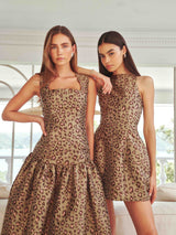 Brunette model wearing Elara Tulip Mini Dress in Leopard Print campaign shot