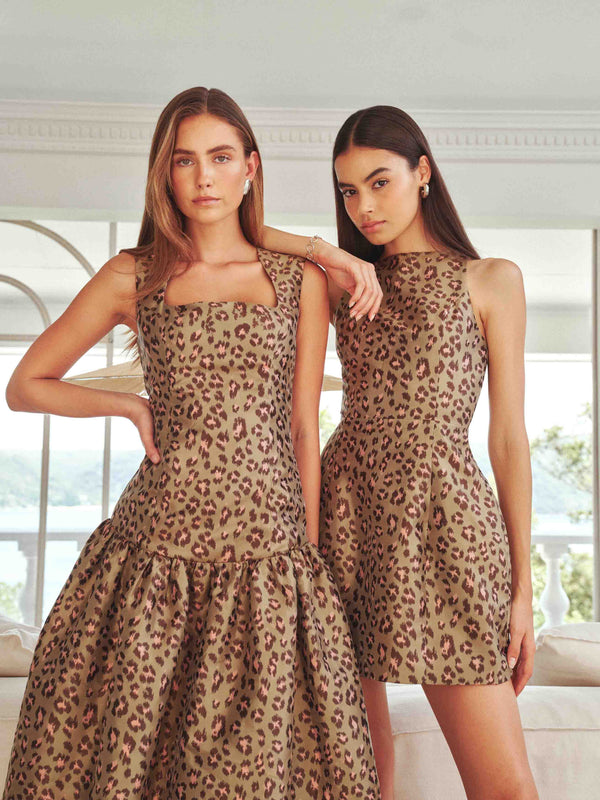 Brunette model wearing Elara Tulip Mini Dress in Leopard Print campaign shot