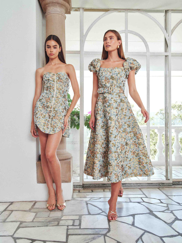 Brunette model wearing Tasmin Puff Sleeve Midi Dress in Blue & Yellow Floral campaign Shot