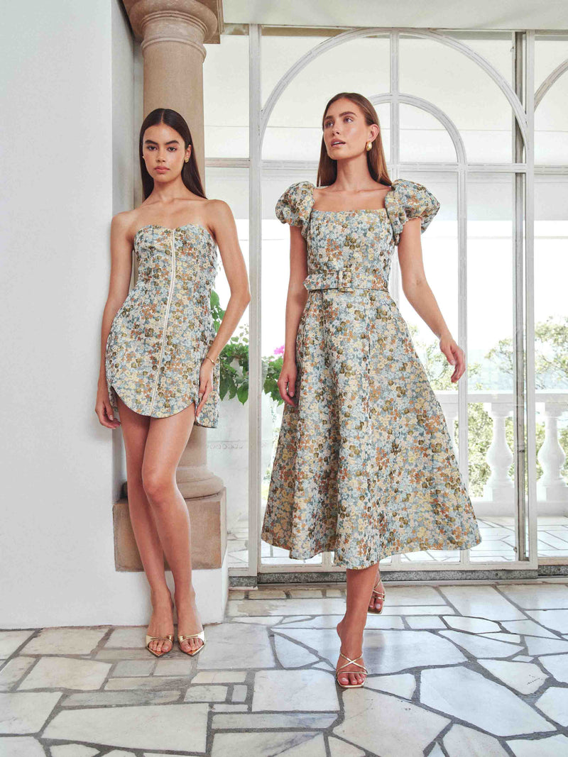 Brunette model wearing Tasmin Puff Sleeve Midi Dress in Blue & Yellow Floral campaign Shot