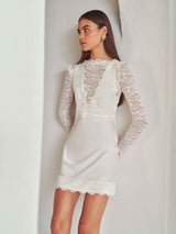 Brunette model wearing the Margot Long Sleeve Mini Dress in White campaign shot