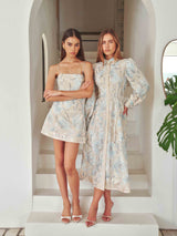 Brunette model wearing Nia Embroidered Mini Dress in Beige campaign Shot