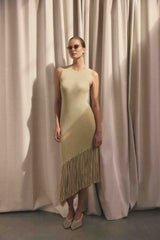 Brunette model wearing the CURAAE Selah Asymmetrical Midi Dress in Beige campaign shot 