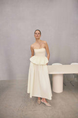 Brunette model wearing Delia Top & Skirt Set in White campaign shot