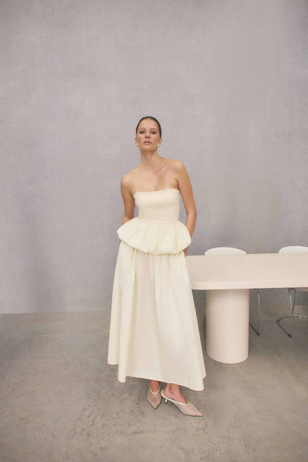 Brunette model wearing Delia Top & Skirt Set in White campaign shot