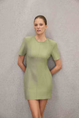 Blonde model wearing CURAAE Dua Short Sleeve Mini Dress in Green campaign shot