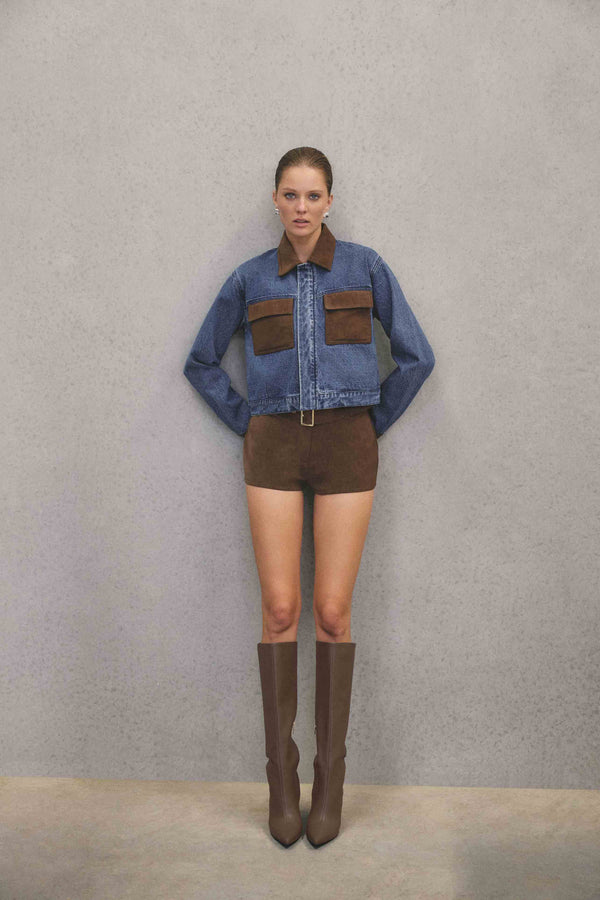Brunette model wearing CURAAE Rhea Denim Jacket & Skirt Set campaign pose