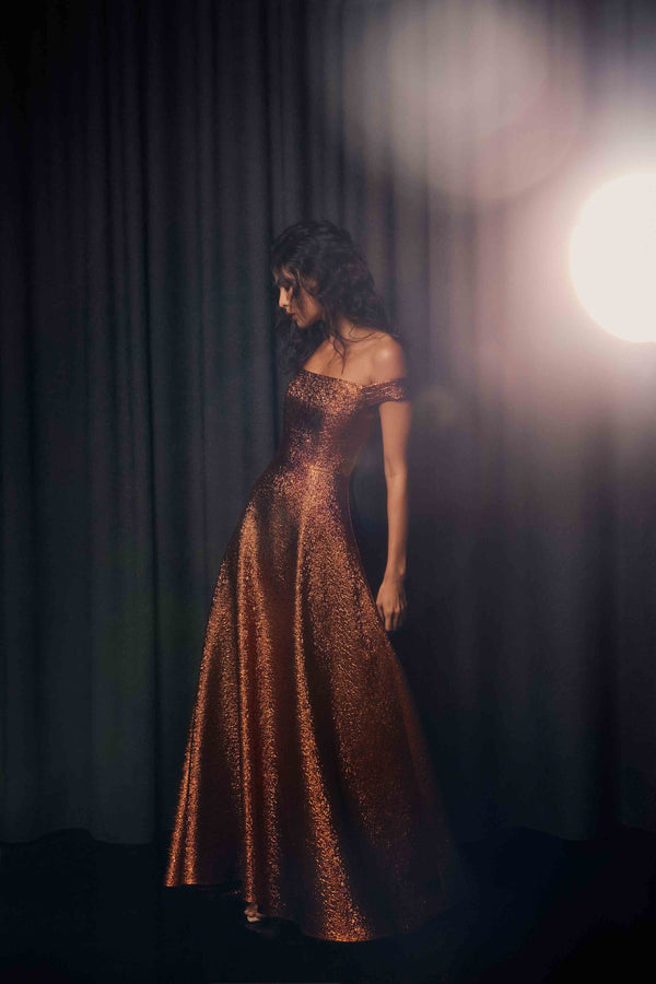 Brunette model wearing the Sapphira Off The Shoulder Gown in Orange campaign shot 