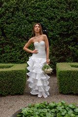 Brunette model wearing the Evelin Tiered Gown in White campaign shot