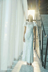 Brunette model wearing the Rina Puff Sleeve Gown in White campaign shot