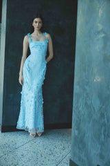 Brunette model wearing the Rina Embellished Gown in Blue campaign shot 