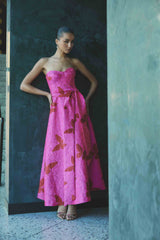 Brunette model wearing The Lorena Jacquard Strapless Gown in Pink campaign shot
