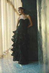 Brunette model wearing the Evelin Tiered Gown in Black front shot 