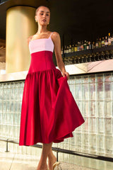 Brunette model wearing the June A-Line Gown in Pink & Red campaign shot 