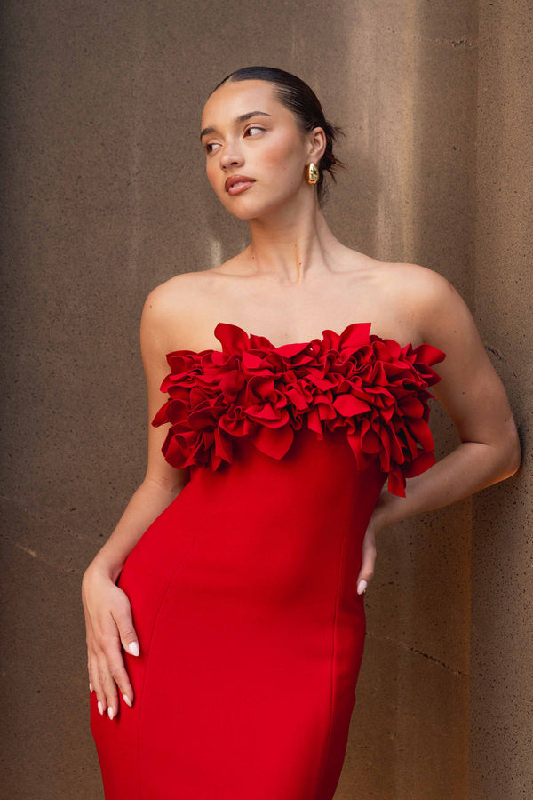 Brunette model wearing the Lila Fitted Midi Dress in Red close up campaign shot
