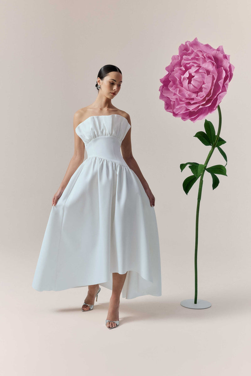 Brunette model wearing the Laurel Sleeveless Maxi Dress In White campaign shot 