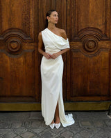 Brunette model wearing Isadora Off The Shoulder Maxi Gown in Ivory campaign shot