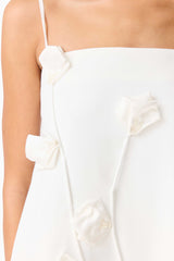Brunette model wearing Nolana Floral Applique Gown in White close up detail shot