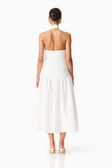 Brunette model wearing the Nolana Halter Midi Dress in White back shot