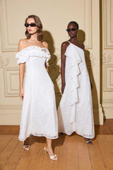 Models wearing CURAAE Elen Off Shoulder Midi Dress in white with frill off shoulder detailing and lace fabrication front shot & the CURAAE Elen Ruffle Maxi Dress in White to cocktail event 