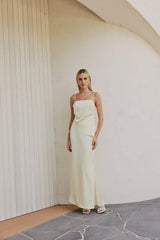 Blonde model wears CURAAE Spencer Asymmetrical Spagetti Strap Cami Top In Coco front shot