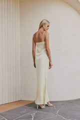 Blonde model wears CURAAE Spencer Asymmetrical Spagetti Strap Cami Top In Coco back shot