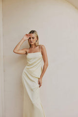 Blonde model wears CURAAE Spencer Asymmetrical Spagetti Strap Cami Top In Coco mood shot