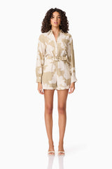 Brunette model wearing CURAAE Wisteria Long Sleeve Jumpsuit in White & Beige front shot