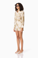 Brunette model wearing CURAAE Wisteria Long Sleeve Jumpsuit in White & Beige side shot