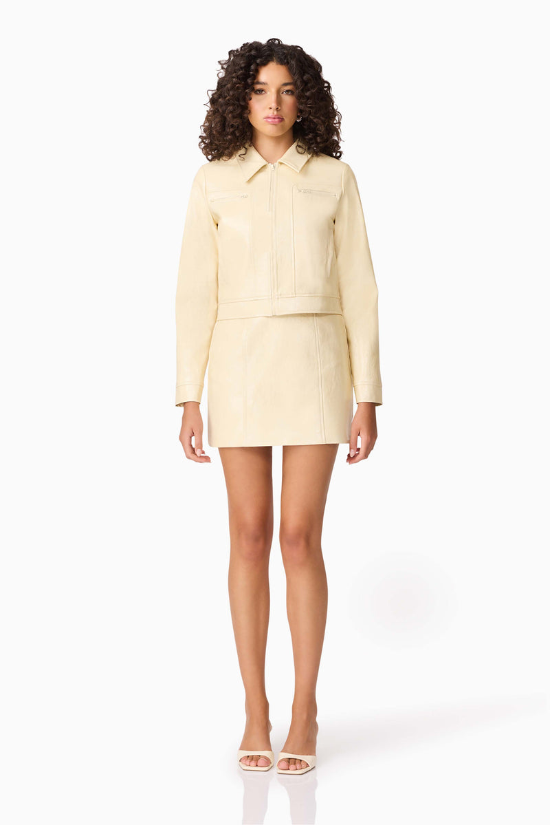 Brunette model wearing CURAAE Airlie Jacket & Mini Skirt Set in Yellow front shot
