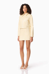 Brunette model wearing CURAAE Airlie Jacket & Mini Skirt Set in Yellow side shot