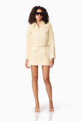 Brunette model wearing CURAAE Airlie Jacket & Mini Skirt Set in Yellow posed shot