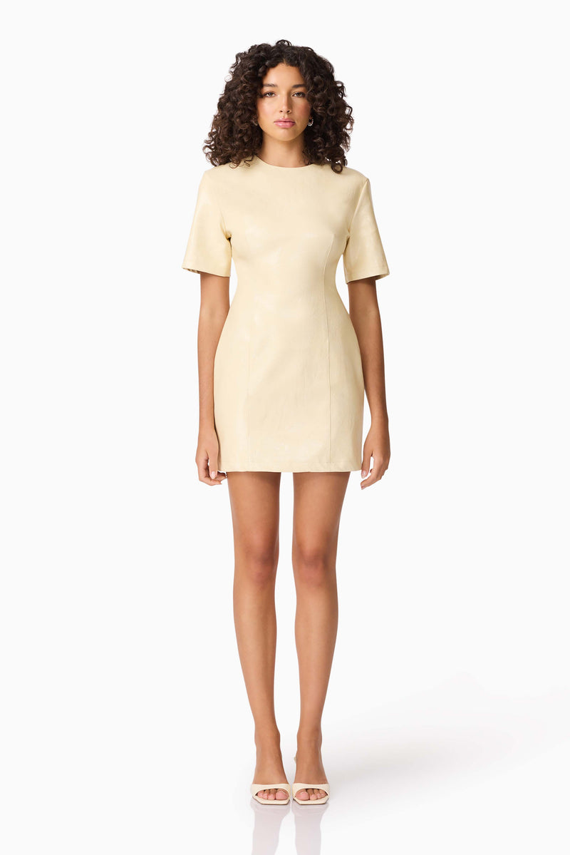 Brunette model wearing CURAAE Airlie Short Sleeve Mini Dress in Yellow front shot